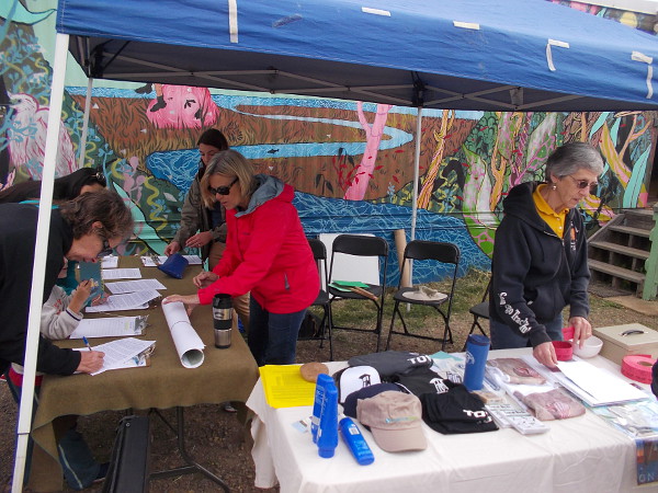 People sign in to the event. A few lucky attendees won raffle prizes!