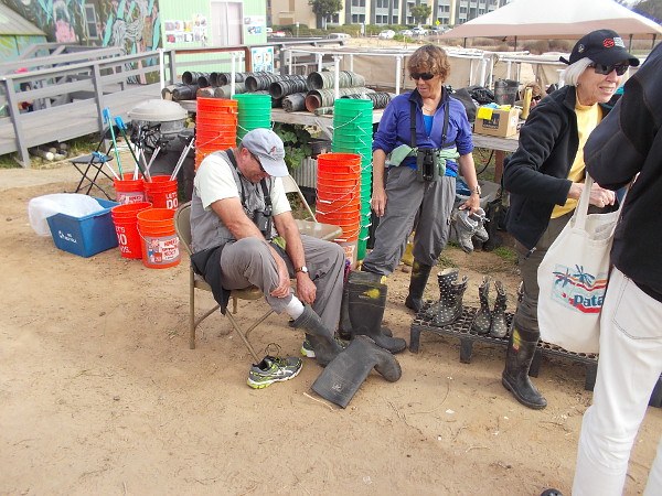 Putting on some boots before heading out into the muddy, mucky marsh!