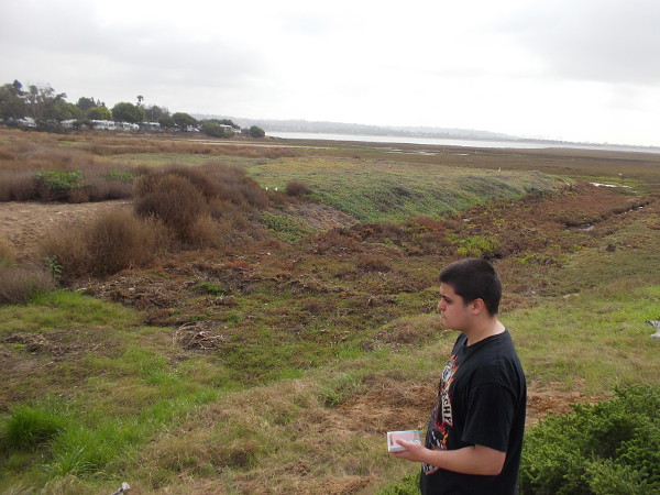 Walking over to collect a water sample. The Kendall-Frost Mission Bay Marsh Reserve habitats include coastal sage scrub, south coastal salt marsh, tidal channels, salt flats and mudflats.