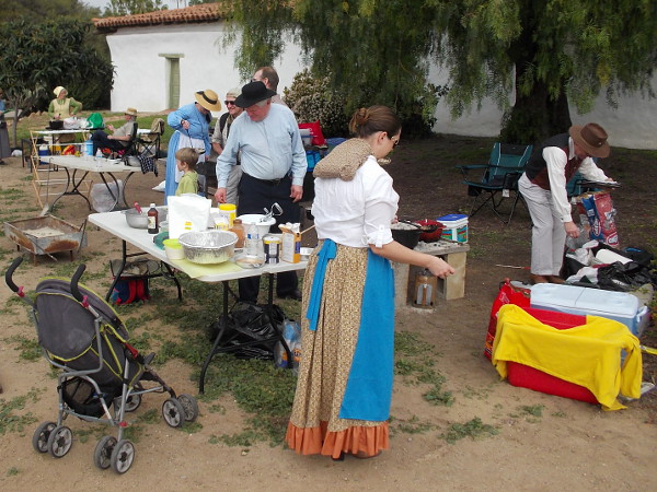 Contestants in a Dutch Oven Bake Off prepare their tasty concoctions for the judges.