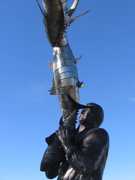 An arch of abundant fish above tuna cannery workers. Public artwork that honors an important chapter in San Diego's history.
