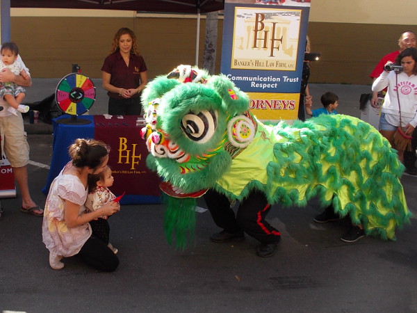 Lion dancer meets small visitor to the 34th Annual 2016 San Diego Chinese New Year Food and Cultural Fair.