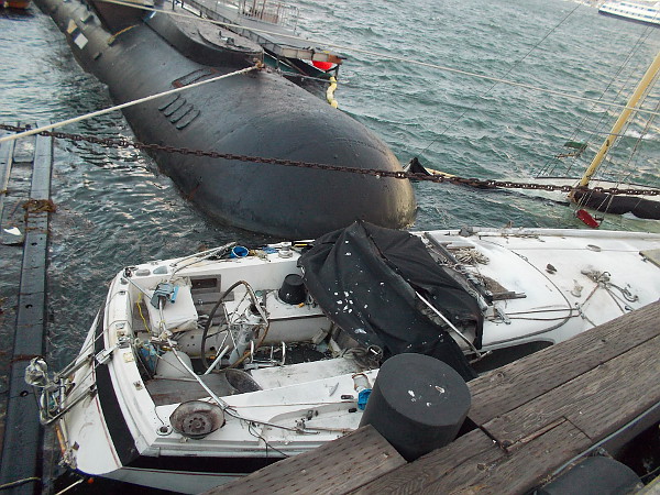 A small boat between the museum's deep diving Dolphin submarine and the pilings. I was told the restored Swift Boat owned by the Maritime Museum of San Diego sustained some damage.