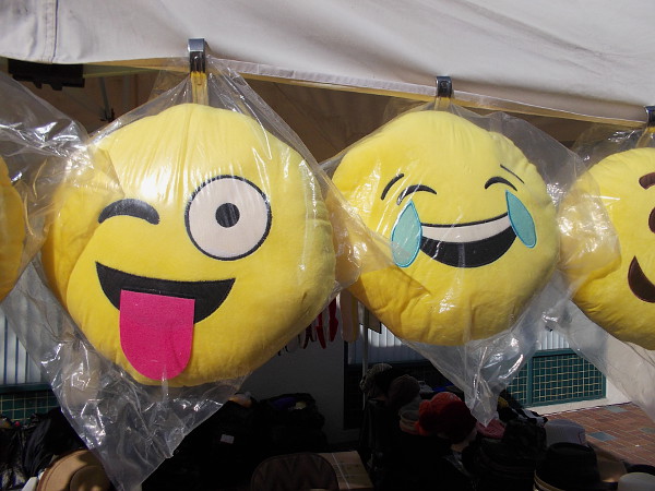 These funny faces were for sale in a vendor's booth. There was lots of Chinese food and a variety of colorful wares for visitors to purchase.