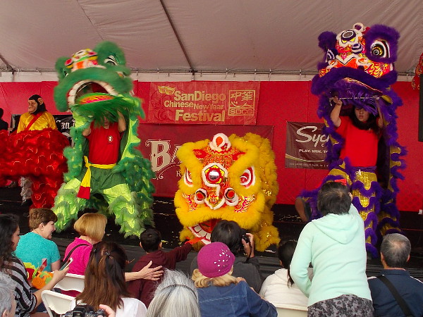 The energetic, exciting lion dance resumed, and people fed the lions red envelopes full of money for good luck!