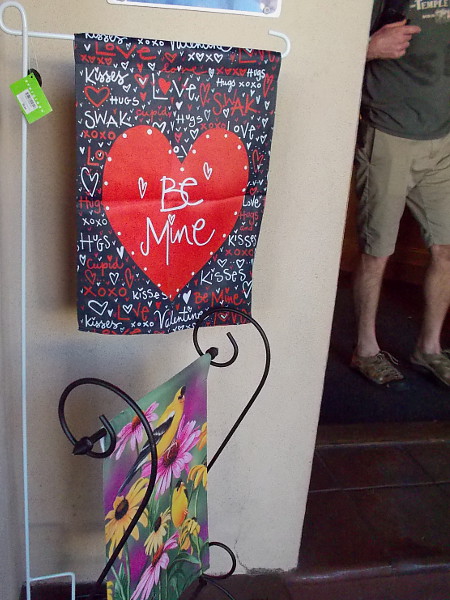 A BE MINE heart banner welcomes people at the door of the Balboa Park Visitors Center.