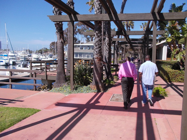 Visitors walk through Marina Village on Mission Bay.