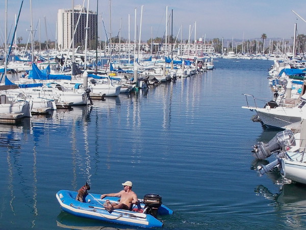 Kicking back with a best friend on the blue water. In the distance you can see the Hyatt Regency Mission Bay Spa and Marina.