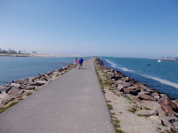 Walking along the jetty west of Hospitality Point. This narrow strip of land separates the San Diego River, to the left, from the man-made channel into Mission Bay. One can see a sliver of Ocean Beach, on the left, and Mission Beach, on the right.