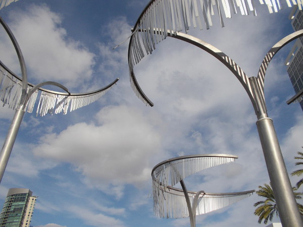 Seven curving metal palm trees rise into the beautiful San Diego sky in Bayfront Plaza.