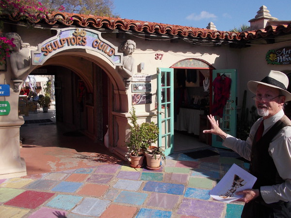 Tour guide Jeff explains that today's Studio 36 Sculpture Guild was an outdoor theatre in the early years of Spanish Village. The front was a lobby and ticket booth. Writers, actors and set designers would act out plays on the inner patio.