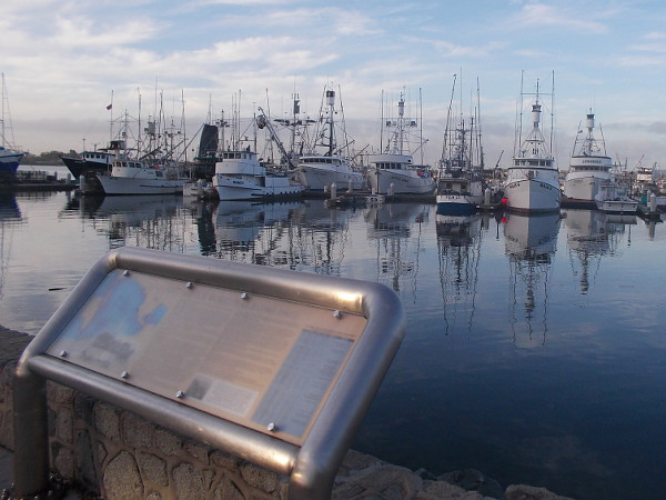 Information sign beside Tuna Harbor, in downtown San Diego, describes how local tuna boats were utilized in the Pacific Ocean theater of World War II.
