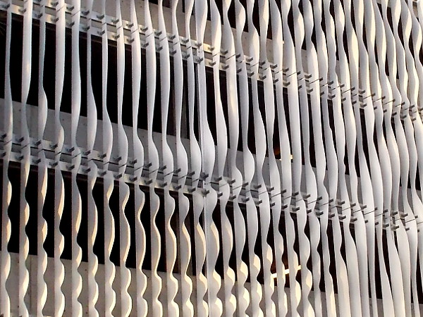 Closer photo of the uniquely undulating artwork, which conceals parking garage levels.