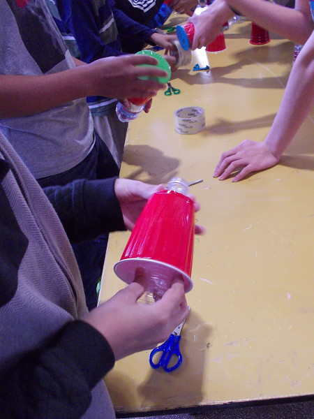 To make a vortex cannon, insert a cut water bottle into a plastic Solo cup.