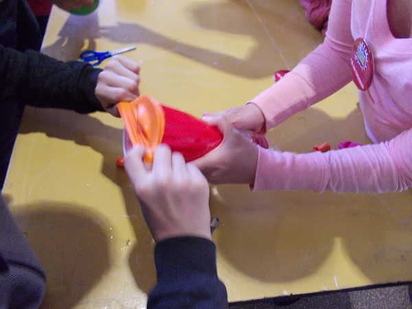 Then cut off the nozzle of a balloon, and stretch the balloon over the open end of the cup.