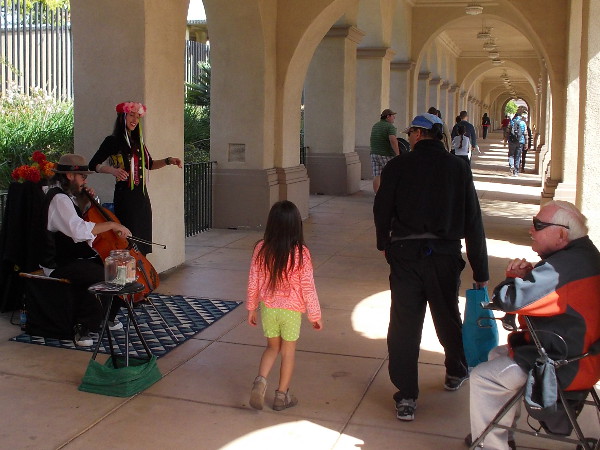 Street musicians add magic to the park, entertaining both young and old.