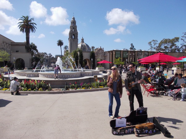 Street performers in the colorful Plaza de Panama. A child readies for a photo on the splashing fountain.