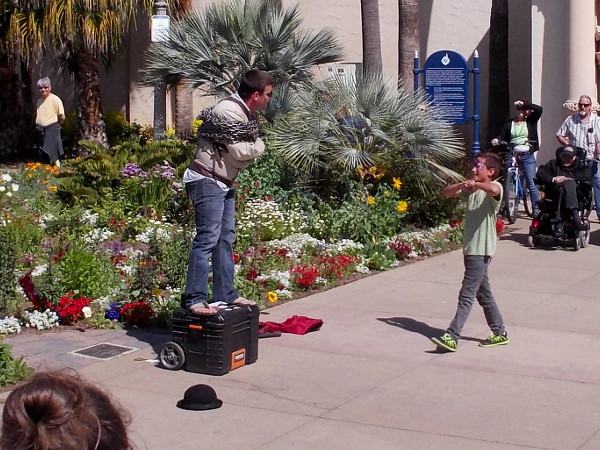 A street performer will attempt to free himself from inescapable chains at the foot of the reflecting pool.