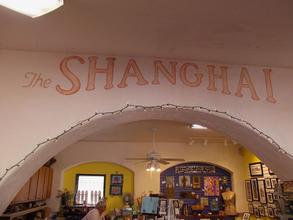 Studio 8, like many others in Spanish Village, was built out from the original open archway to provide more space for the artists. The words The SHANGHAI are from 1935. It evidently used to be a bar.