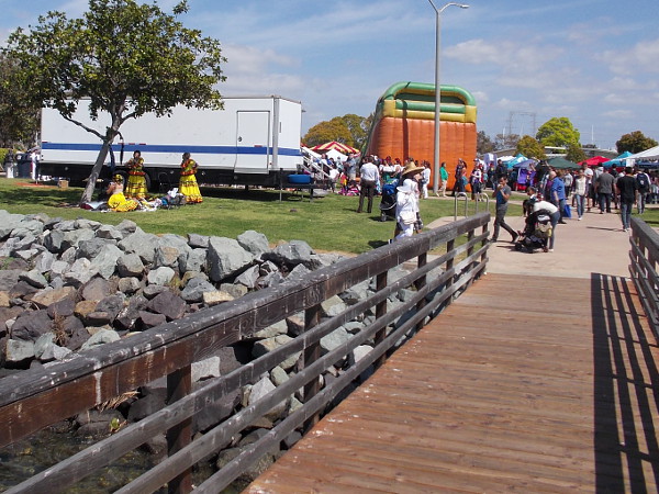 Looking back at the smaller stage. Some dancers wearing bright yellow are getting ready for their turn to perform.