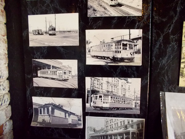 One section of a wall has lots of photos of vintage streetcars and trolleys.