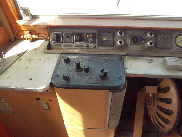 The controls used by the electric streetcar operator. Notice the chair which folds under the dash.