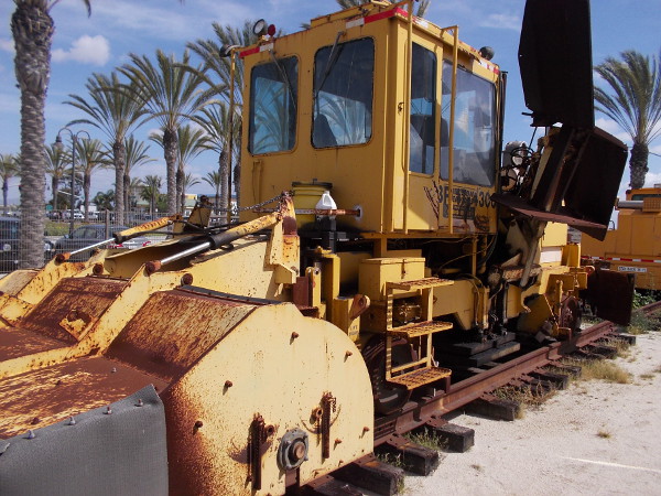 A big, heavy tamping machine used for maintaining railroad tracks and placing them more firmly onto packed ballast.