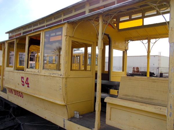 Elegant number 54 was operated by the San Diego Electric Railway Company according to its markings. The yellow paint is peeling.