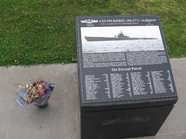 Someone honors submariner heroes by leaving flowers beside a black granite marker that remembers the USS Pickerel (SS-177).