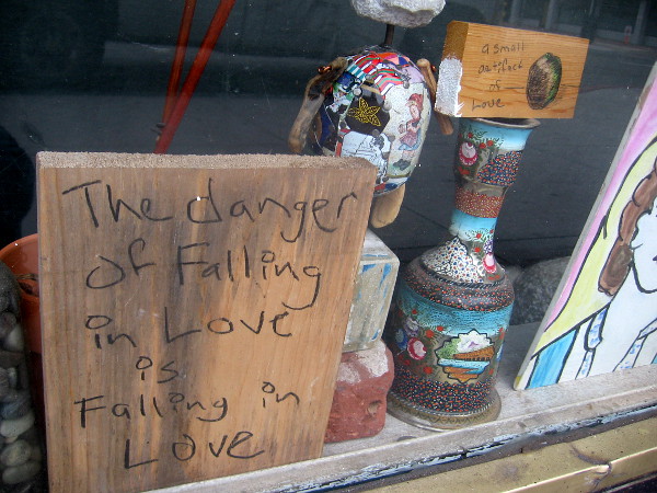 A small handwritten sign seen in a San Diego window. The danger of falling in love is falling in love.