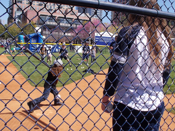 Young batter smashes a hit in the tiny ball field at Park at the Park. Baseball is fun for everyone!