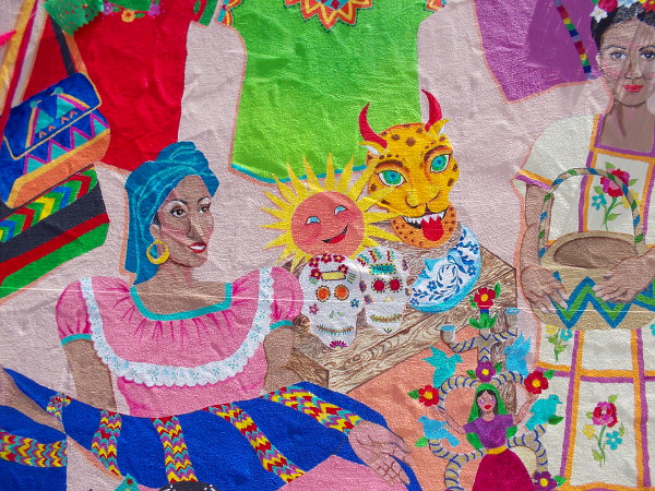 A painting of a market full of Mexican crafts and charm. It makes one feel that life is good, just gazing at this joyful artwork.