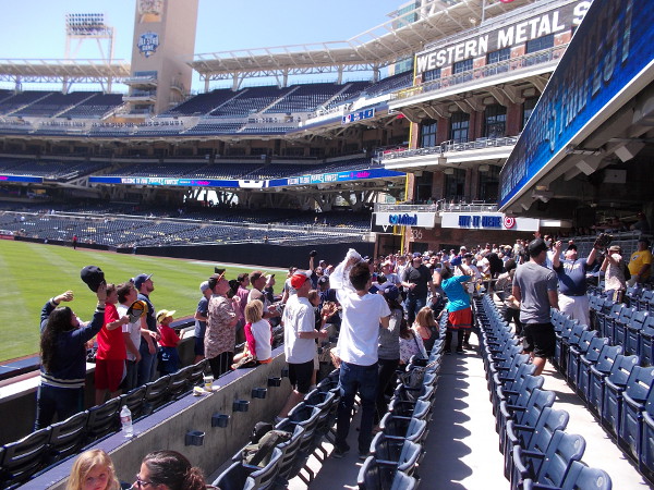 A player smashed a line drive over the wall during batting practice. If someone can catch the ball, they might possibly win a prize: tickets to the Homerun Derby before this year's All-Star Game!