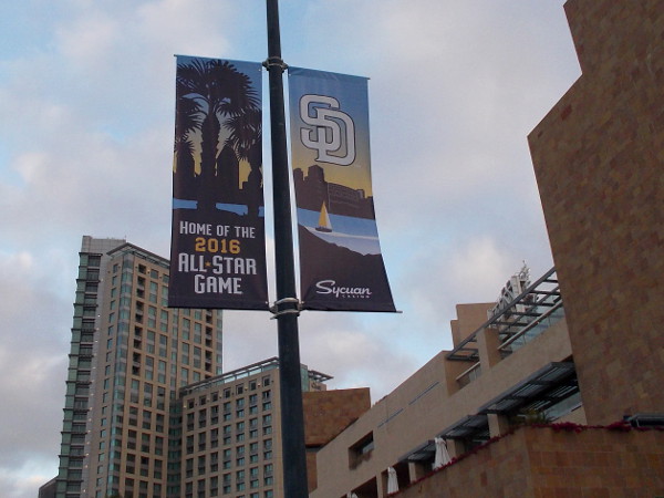 The upcoming All-Star Game appears on a street lamp near Petco Park. These banners can now be seen around East Village.