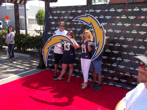 Chargers football fans hold huge bolts for a photograph!