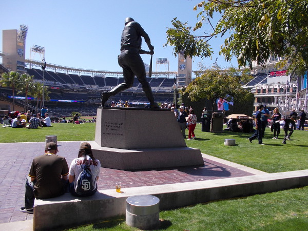 Padres fans rest behind the Tony Gwynn statue atop the hill in the grassy Park at the Park.