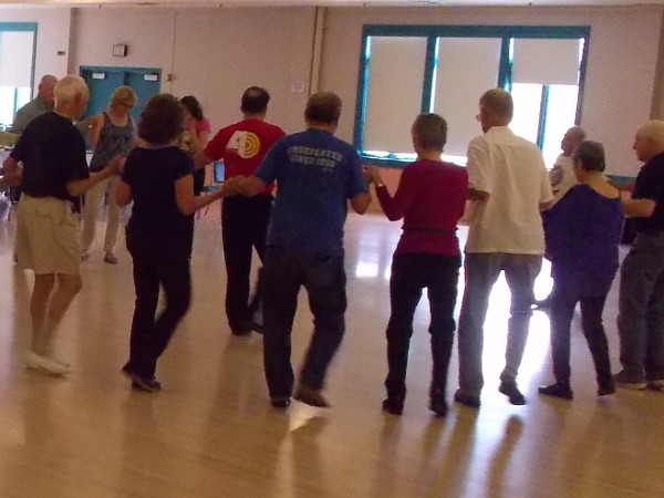 People at the International Folk Dance Spring Festival in Balboa Park learn Greek dancing!