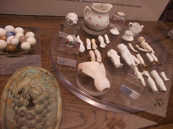 Marbles, doll parts and tiny children's tea sets, recovered from San Diego's past.