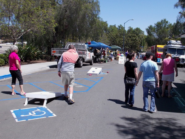Someone tries their hand at a fun bean bag toss game.