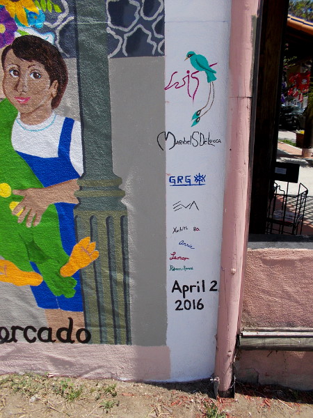 Un dia de Mercado was completed on April 2, 2016. It was painted by several talented artists. Their signatures are evident in this photo. New colorful urban art in Normal Heights!