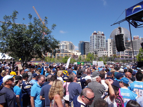A fairly large crowd has gathered in the parking lot near Petco Park where Padres fans often tailgate. The proposed stadium would be built here.