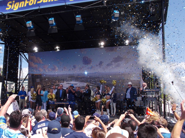 A blast of glitter and raised pom-poms from smiling San Diego Charger Girls cheerleaders as the event comes to a conclusion.