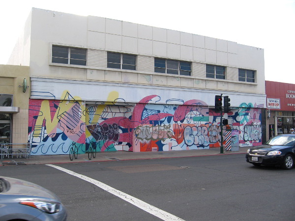 A gritty urban canvas jammed with abstraction and graffiti is glimpsed by drivers heading along University Avenue.