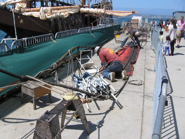 It's Sunday, which is volunteer work day at the maritime museum. If I recall correctly, these guys near the San Salvador were applying tar to some steel cables that will be used on the HMS Surprise.
