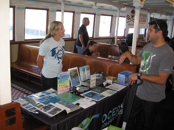 Someone learns about the amazing Eco Tours and the educational programs provided by Ocean Connectors during Earth Bay on the Bay at the Maritime Museum of San Diego.