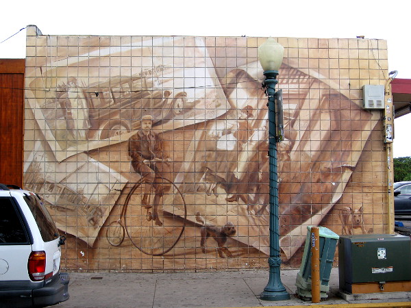 Sepia tone mural on Fern Street in South Park features man riding an old-fashioned penny-farthing and nostalgic images from San Diego's past.