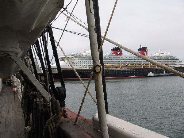 Containing many pleasures, the Disney Wonder cruise ship is docked in San Diego. Seen from the deck of the Star of India.