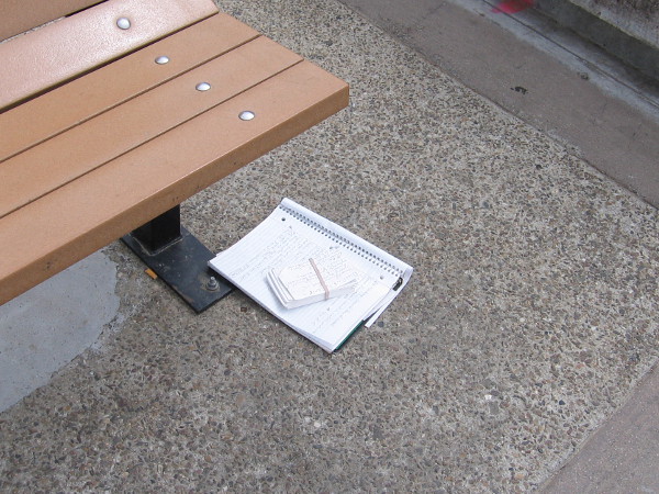 A writer sat here. Words purposefully put down . . . or discarded . . . or forgotten. Many thoughts lie alone by a bench near the water.