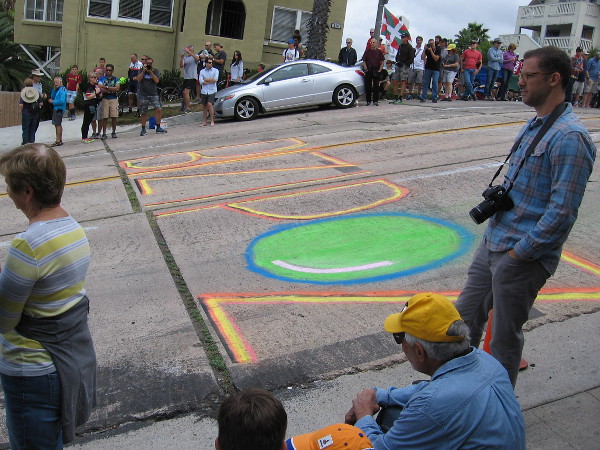 Someone wrote a big word on the street with colorful chalk. I think it reads Bizipoz. I'm not sure, though.