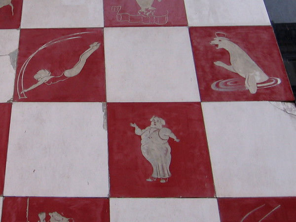 A singing pig is joined by a trapeze artist and a seal in a hat. One often sees images of surfers, Hispanic culture or local landmarks in San Diego--not the circus!